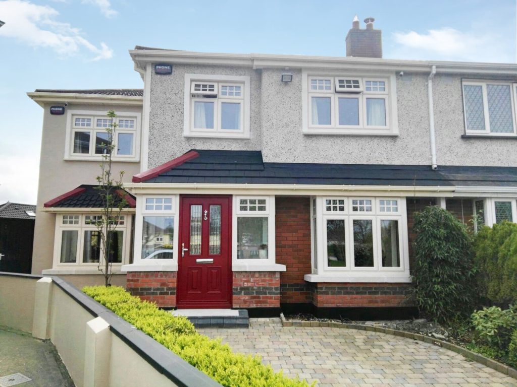 Red Composite Door with cream uPVC windows with triple glazed glass